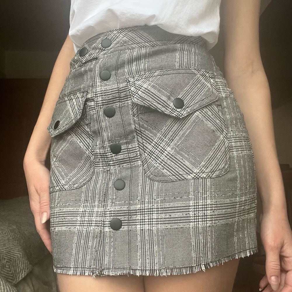 grey plaid skirt with snap buttons in front and pockets